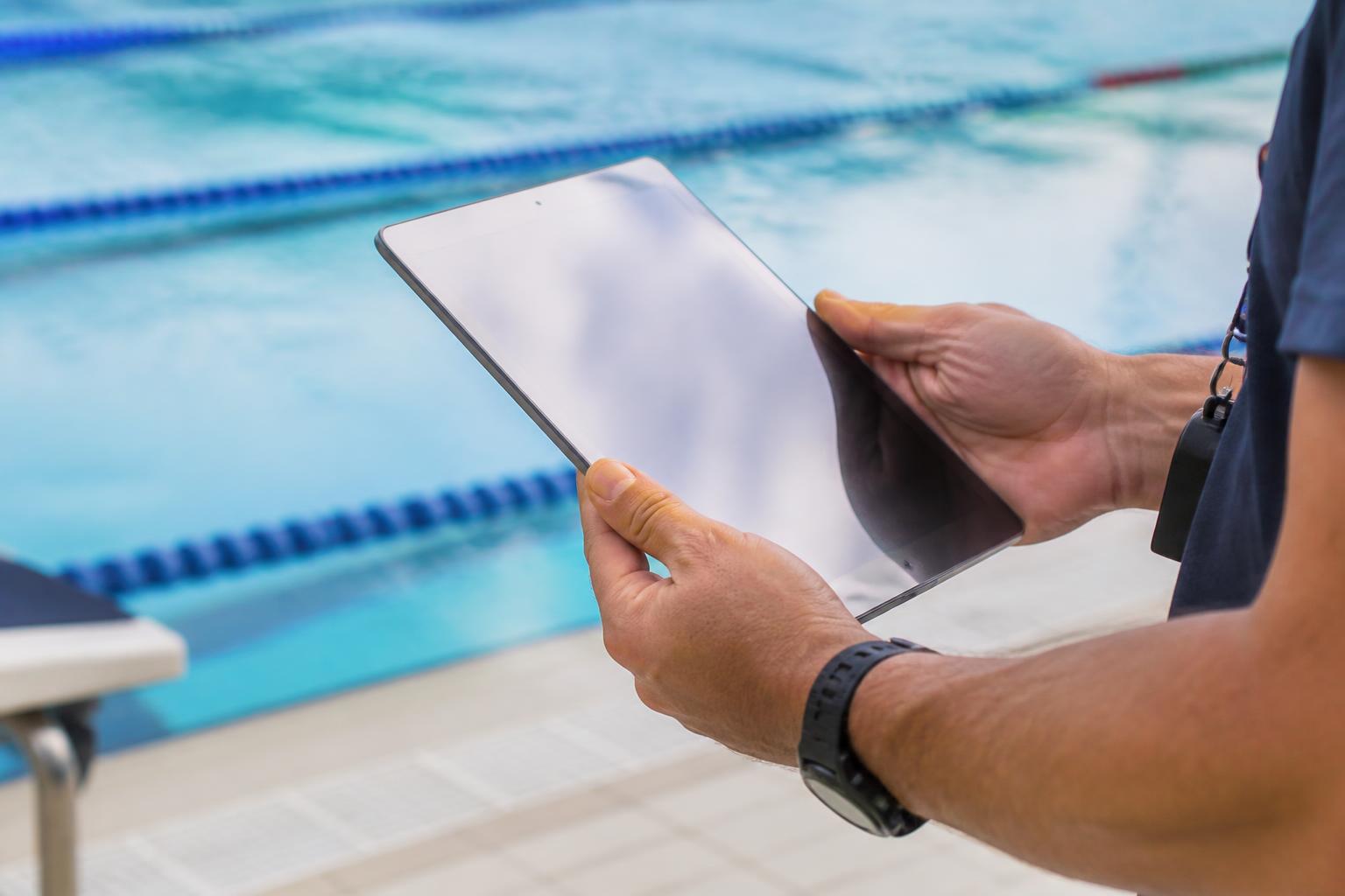 Swimo interactive lesson worksheet on a poolside tablet
